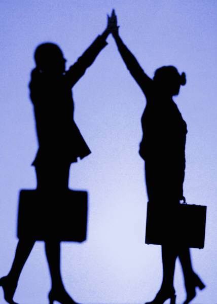 Photo of two silhouettes giving a high five
